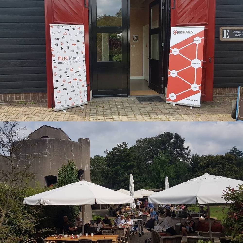 Roll-up banners for a Magento unconference outside an event venue, with a terrace and umbrellas visible.