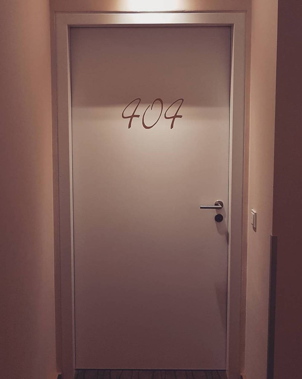 A hotel room door numbered 404.