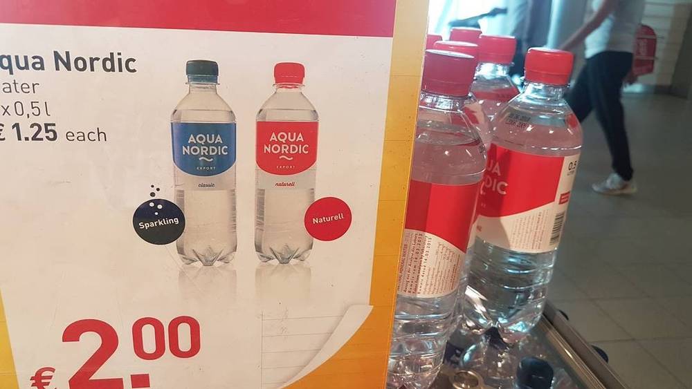 A supermarket sign advertising Aqua Nordic bottled water for €2.