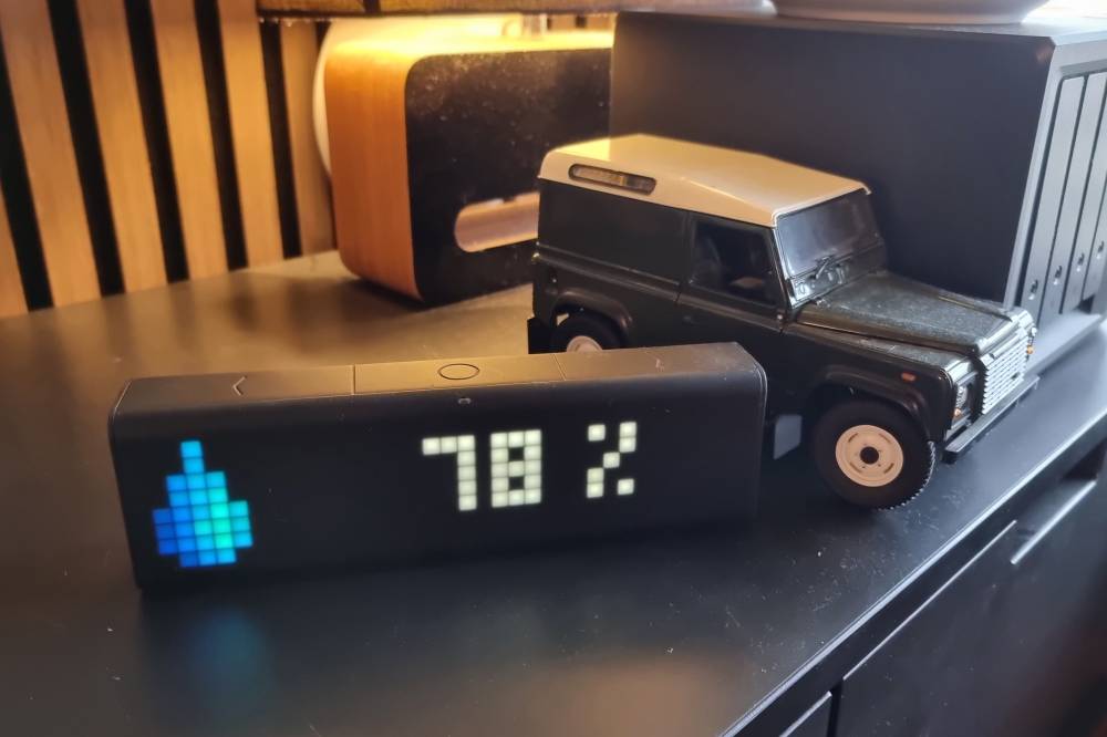 A LaMetric pixel device in front of a miniature Landrover Defender