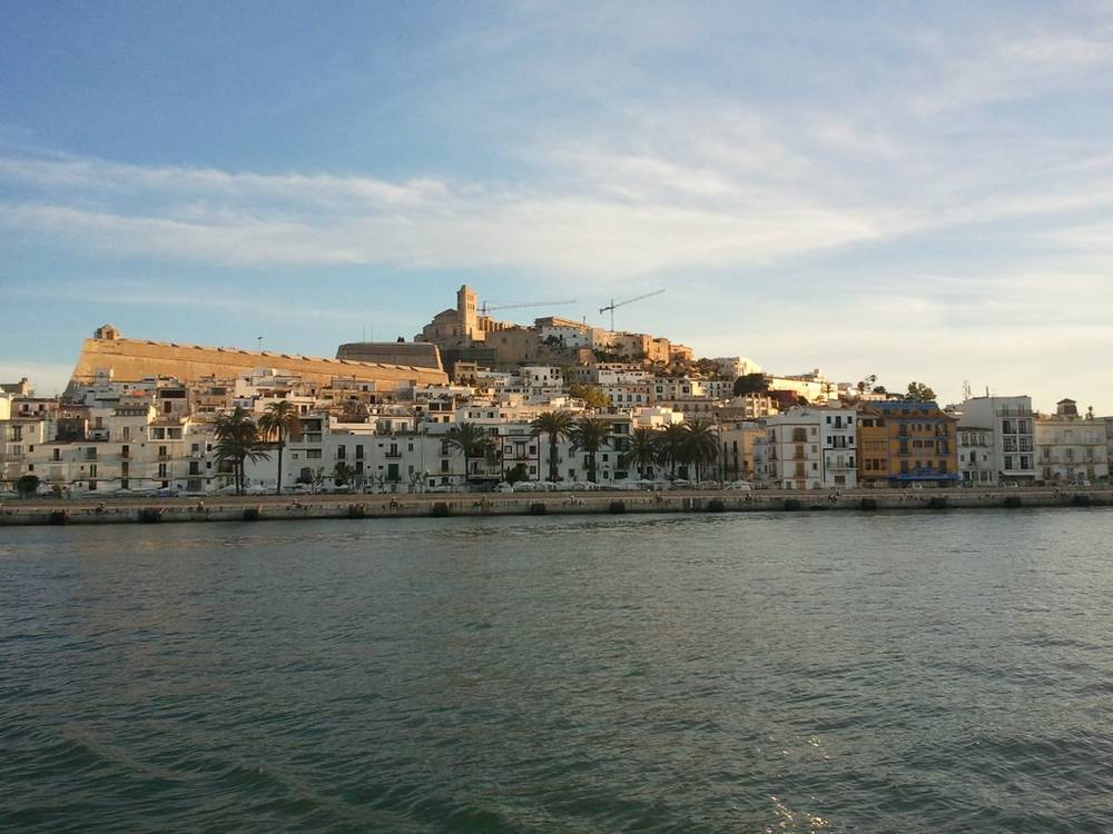 A view from the water of Ibiza's old town and hilltop castle.
