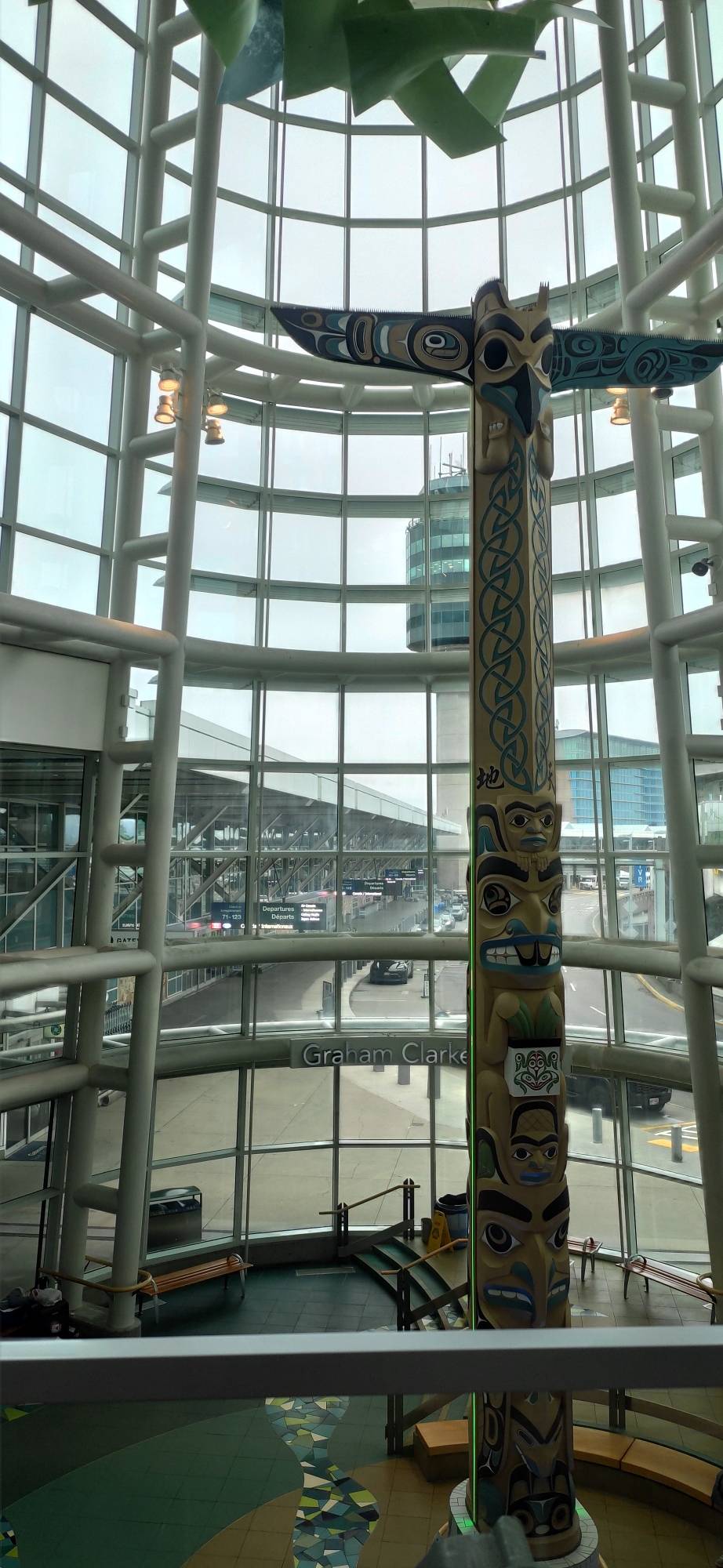 Cool tall indigenous sculpture inside Vancouver's airport, surrounded by windows
