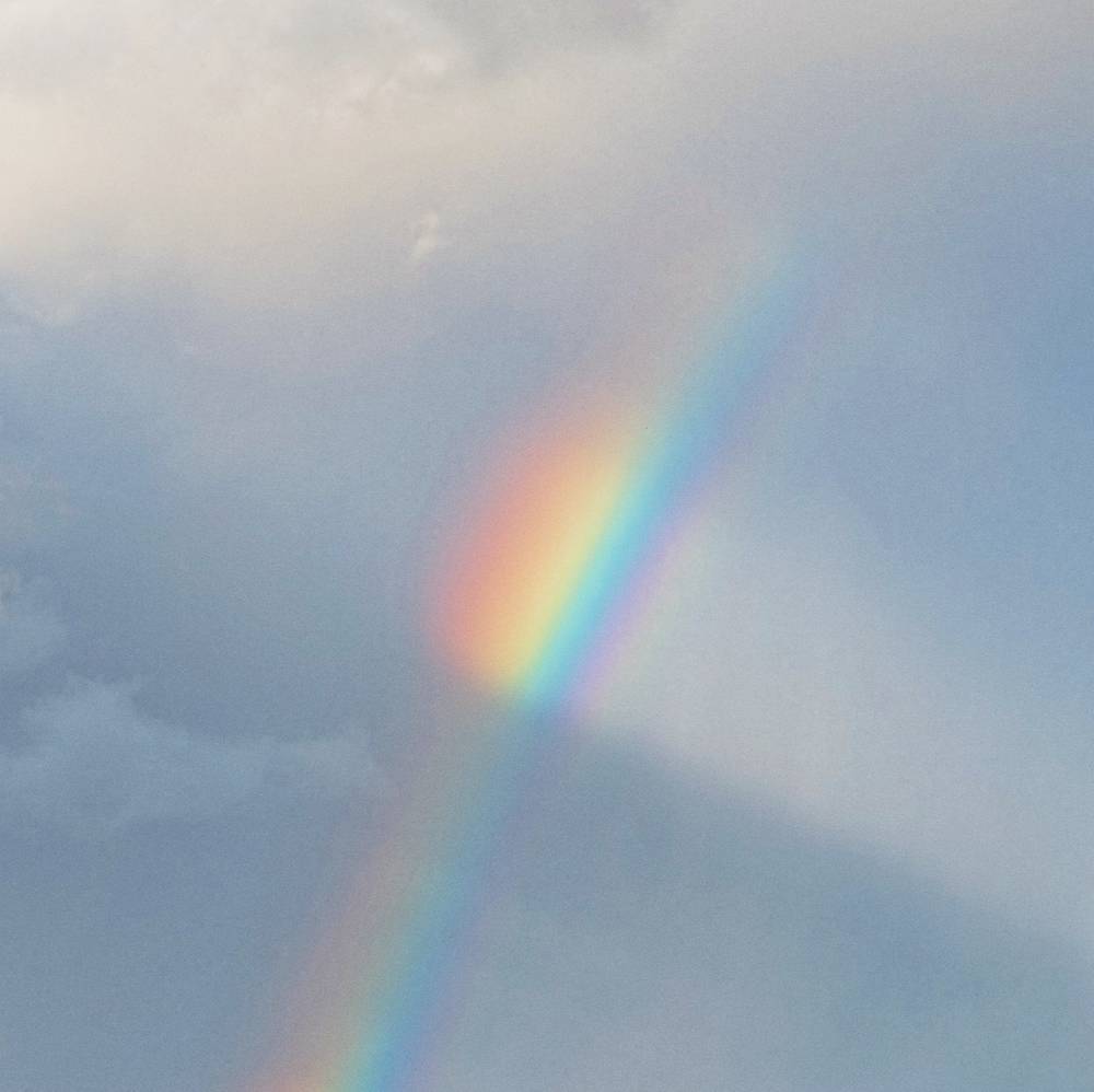 A nice rainbow intersecting a beam of light