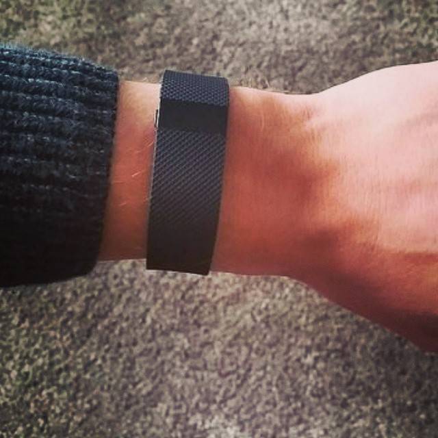A black fitness tracker worn on a wrist, close-up.
