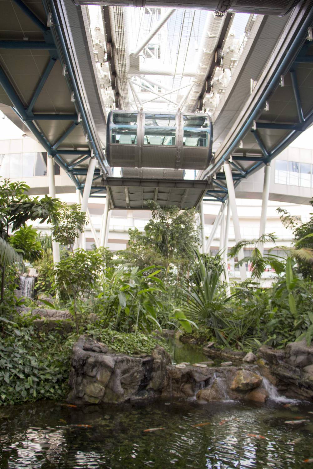 The underside of the Singapore Flyer's capsules and support arms, with a garden below.