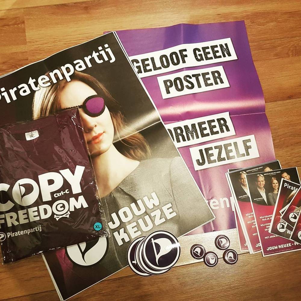 Political flyers for the Dutch Piratenpartij (Pirate Party) with slogans about copy freedom and forming your own opinion.