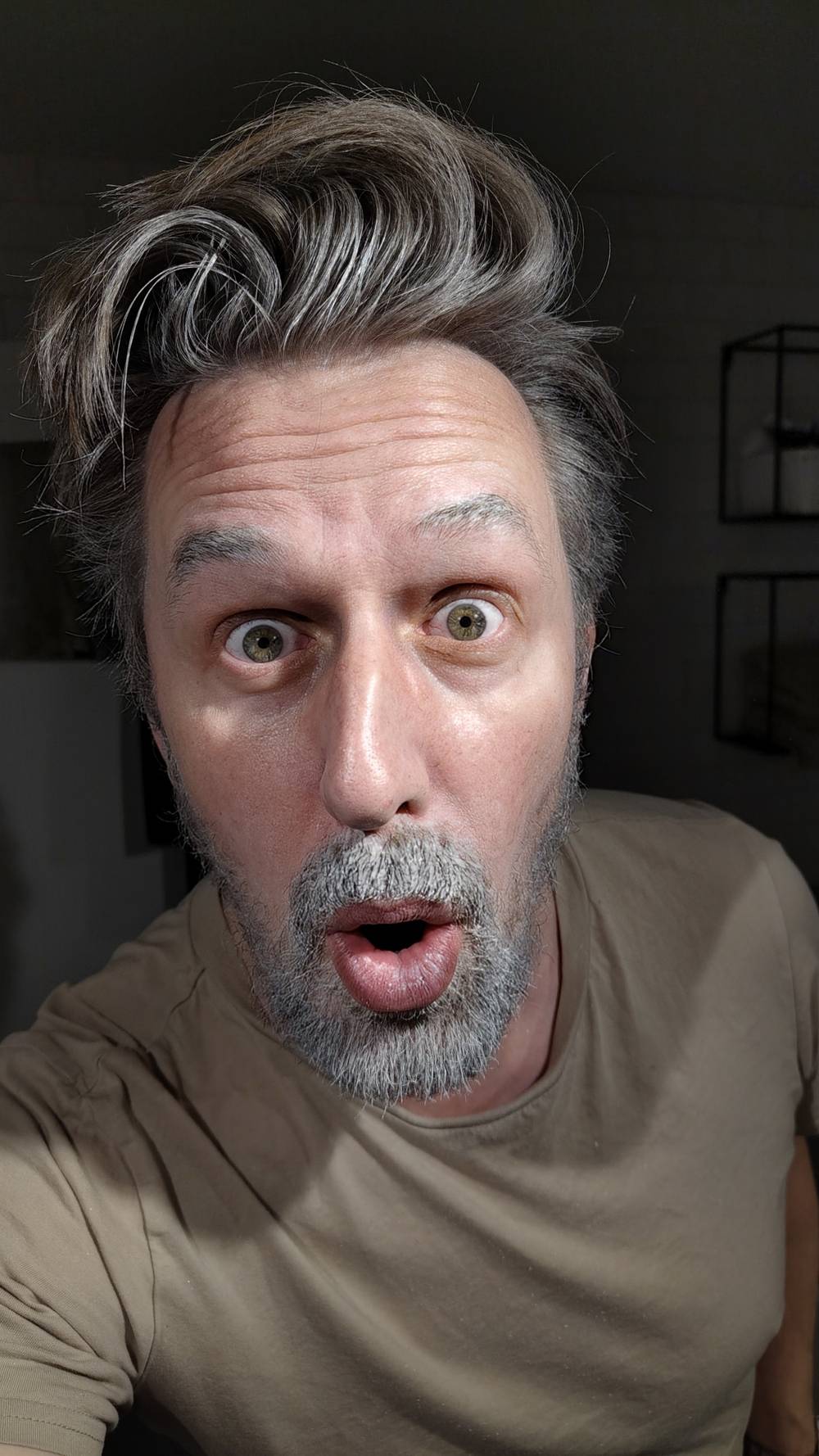 Close-up selfie of a man with a surprised expression.