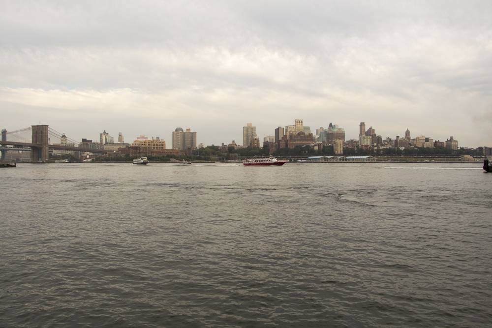 The Brooklyn Bridge and Brooklyn skyline are seen across the East River.