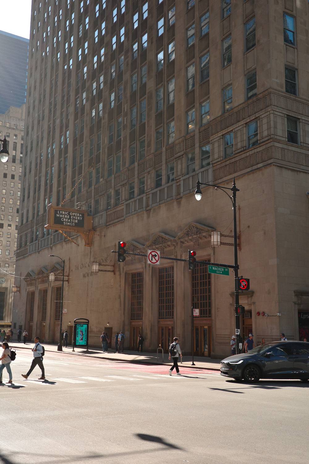 People crossing the street near the Lyric Opera house 