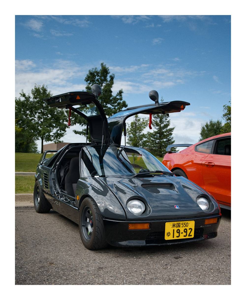3/4 view of the Autozam AZ-1 with it's doors up