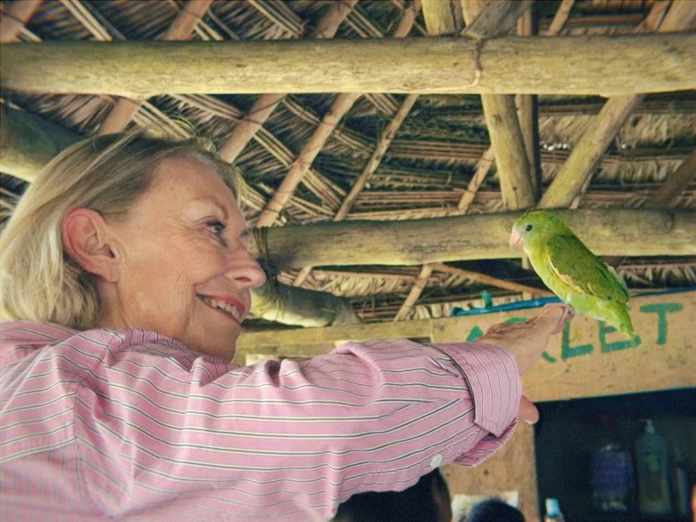 Another tour mate holding a parakeet
