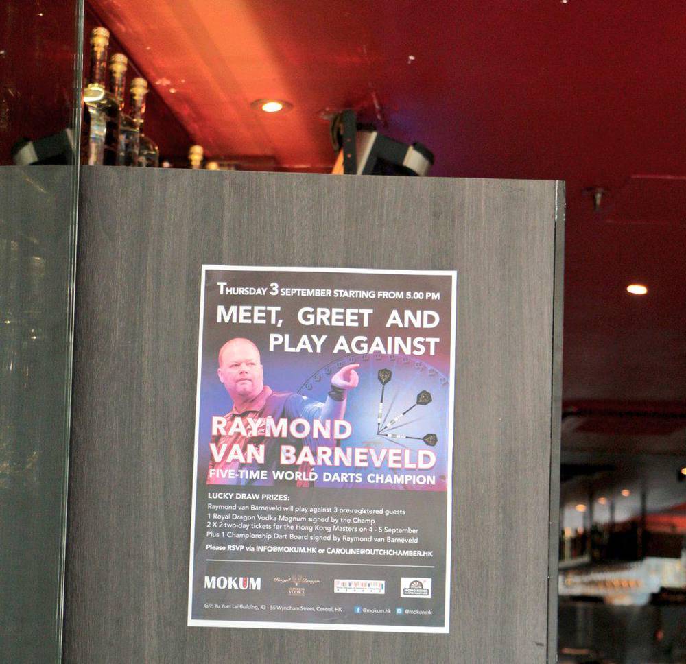 A poster advertising a meet, greet and play event with darts champion Raymond van Barneveld.
