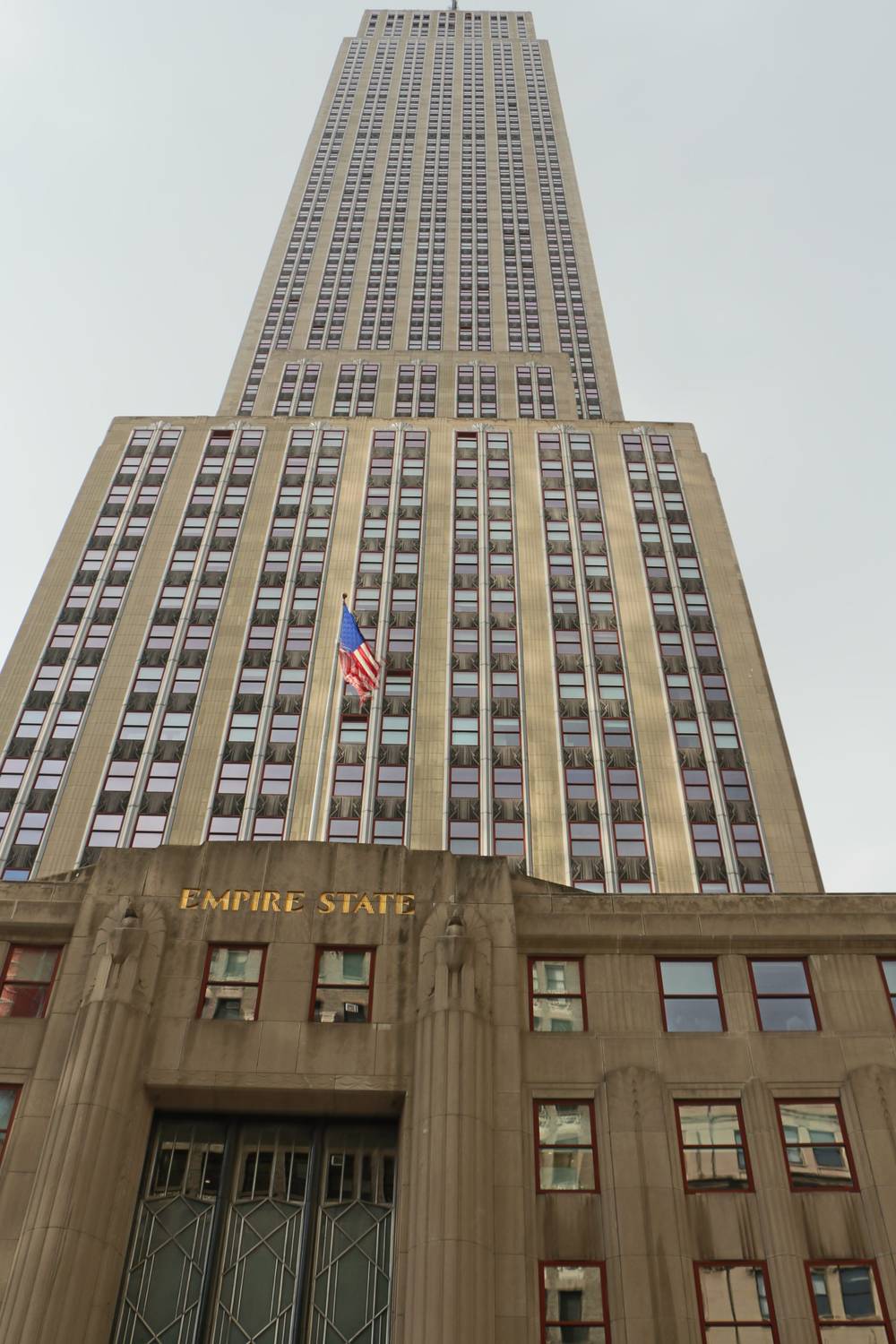 The Empire State Building rises above the street.
