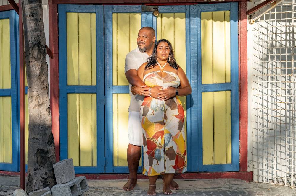 couple against colourful door tropical setting