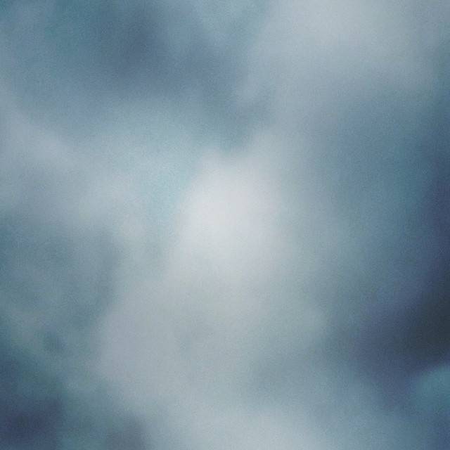A soft, hazy sky filled with pale clouds.