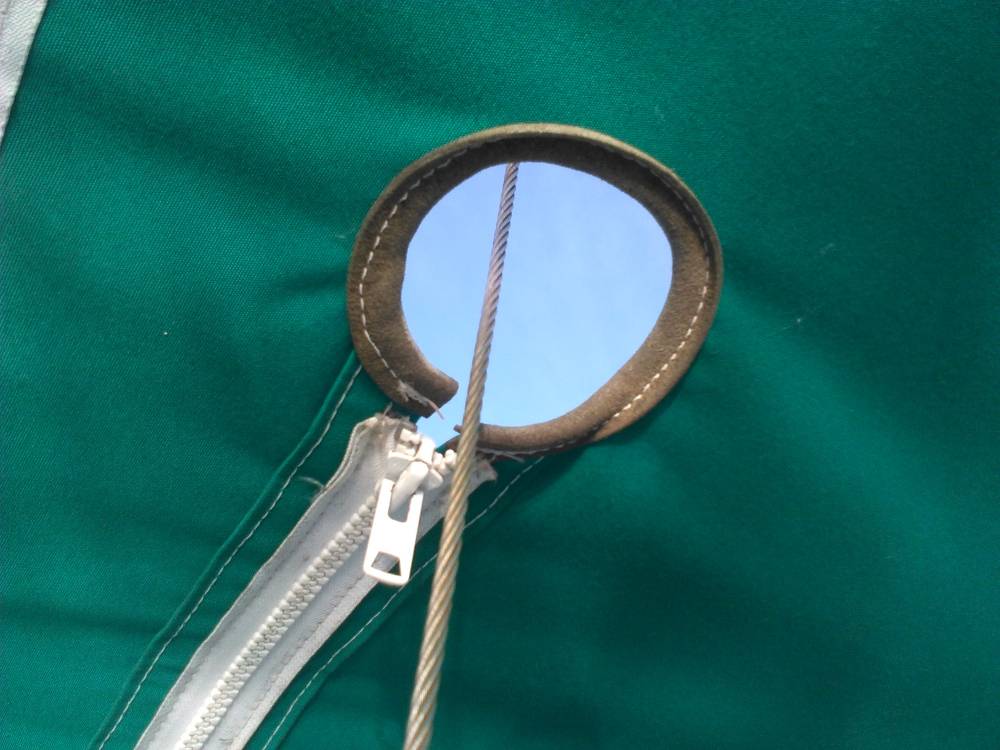 Hole in canvas with a wire going through it
