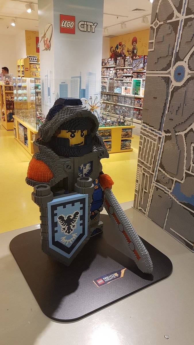 A Lego knight minifigure display stand inside a toy store.