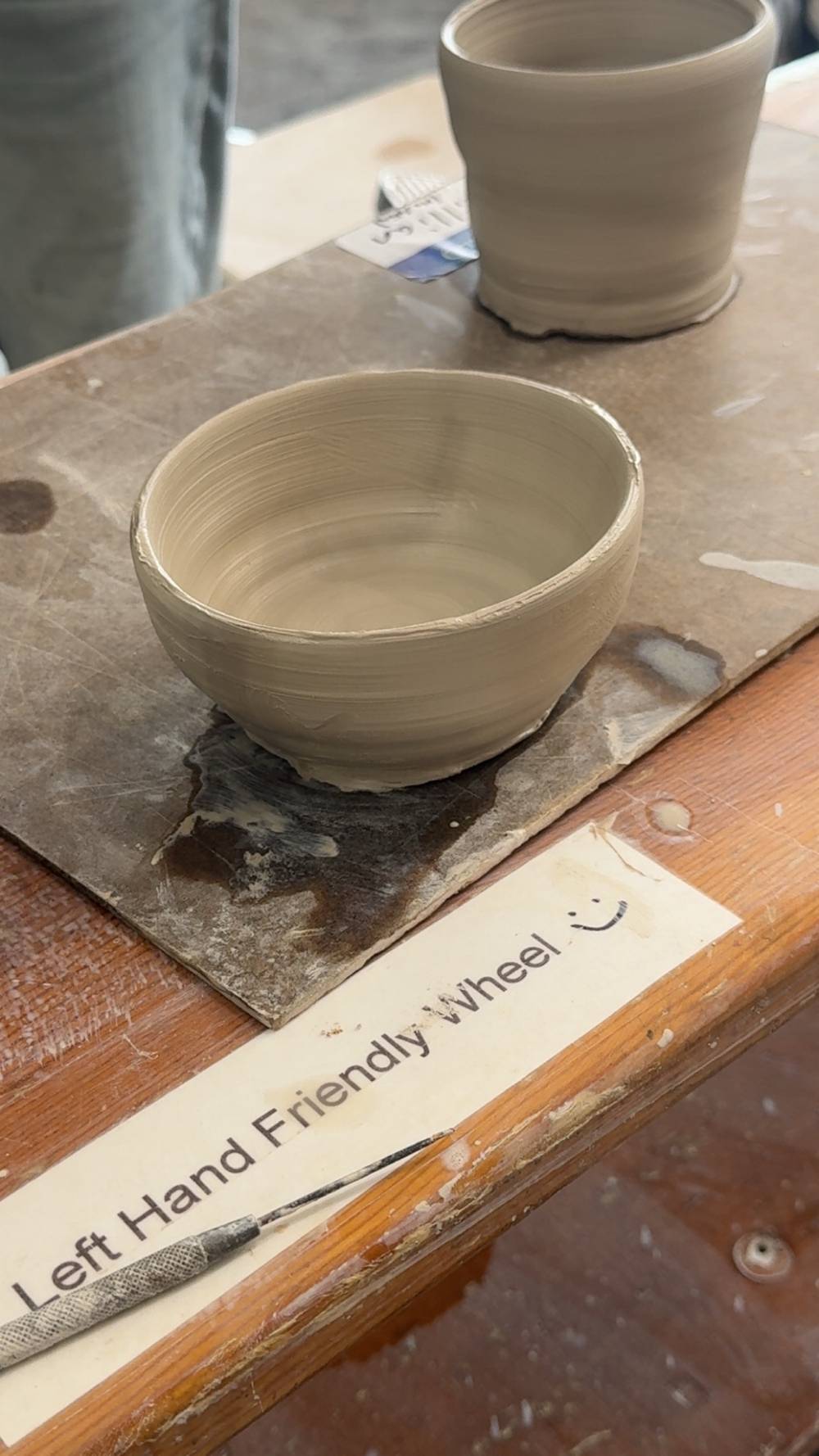 An unfired clay bowl, recently made on a pottery wheel