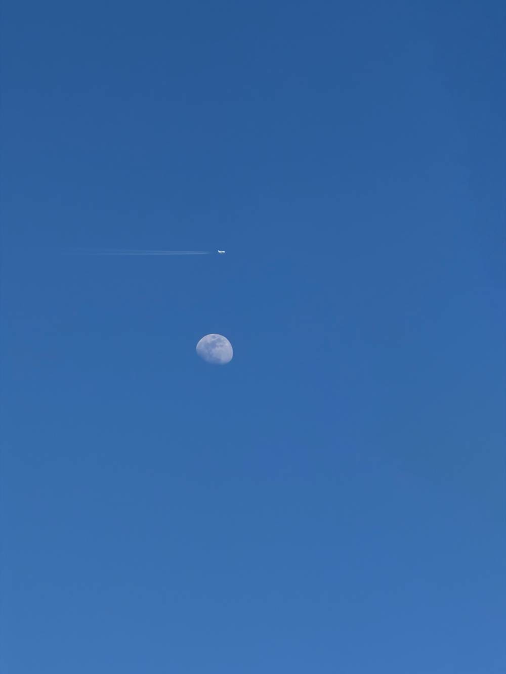 Plane flying over a child’s moon. Plane is center frame