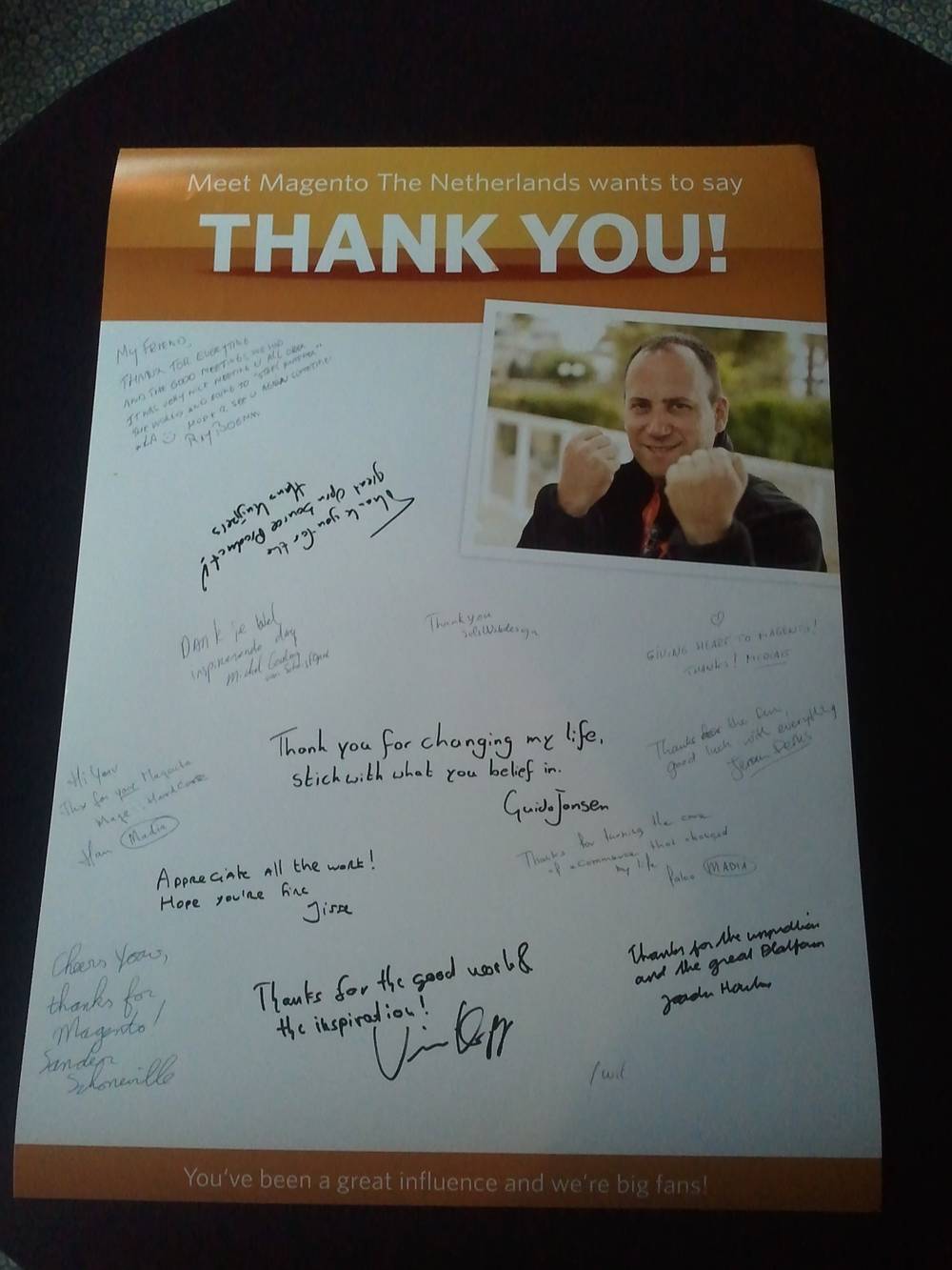 A signed thank-you card from Meet Magento The Netherlands with handwritten notes and a photo of a man giving a thumbs up.