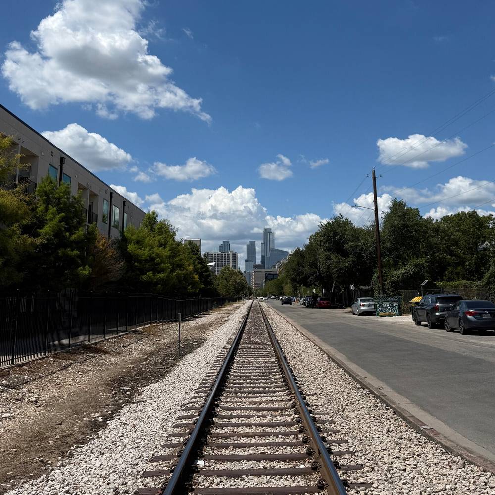 Took a walk the long way around the block from the coffee shop. Austin skyline down the rail line ne, photo 1 of 1