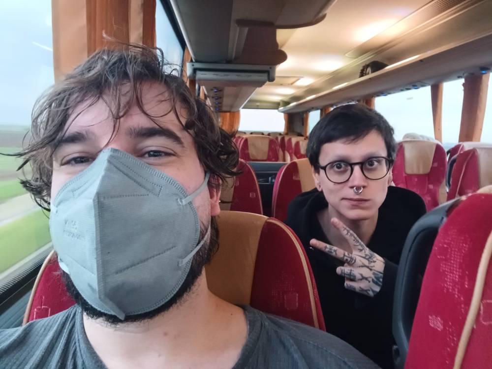 Me n @randomdeadbird.bsky.social on the bus! It's pretty empty which is chill. I'm masked up. 