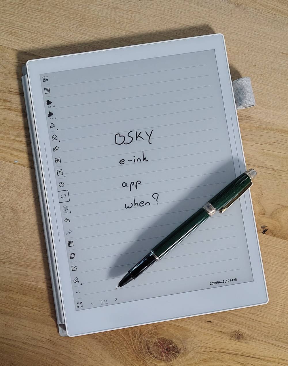 A handwritten note on an e-ink tablet reads "BSKY, e-ink, app, when?" beside a pen.