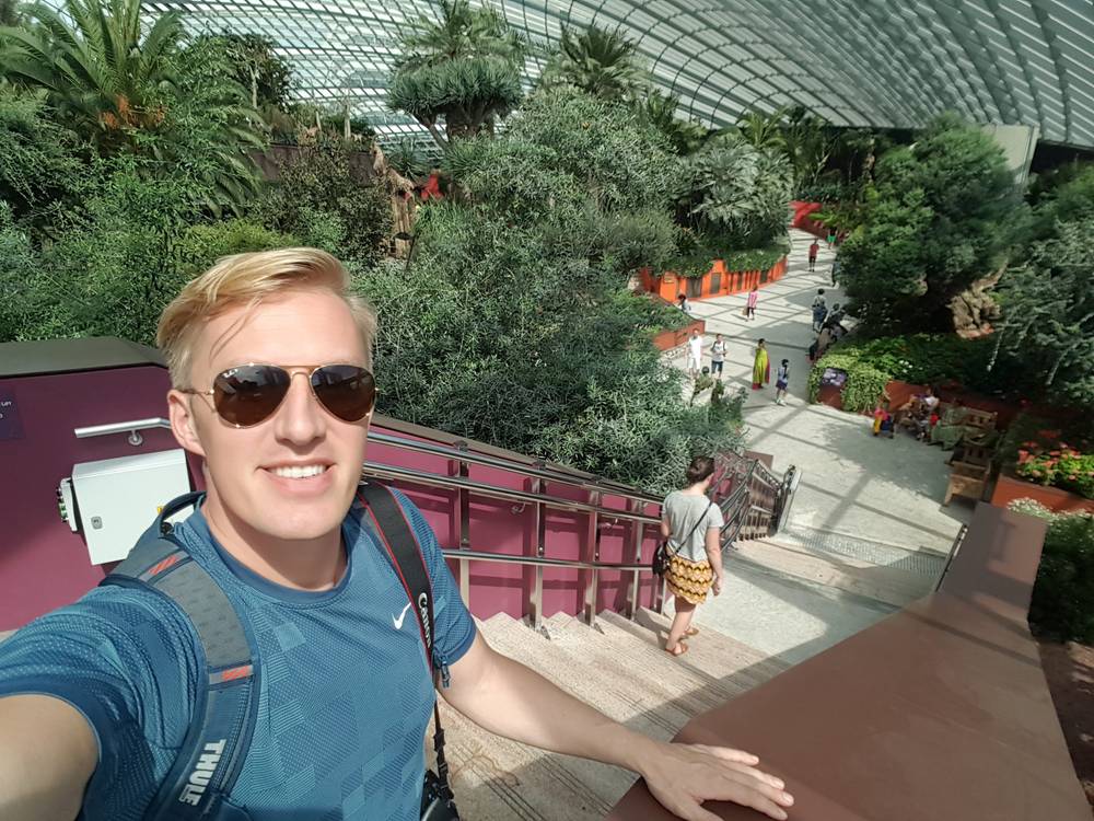 Guido takes a selfie on the Cloud Forest skywalk, arm outstretched toward the garden below.