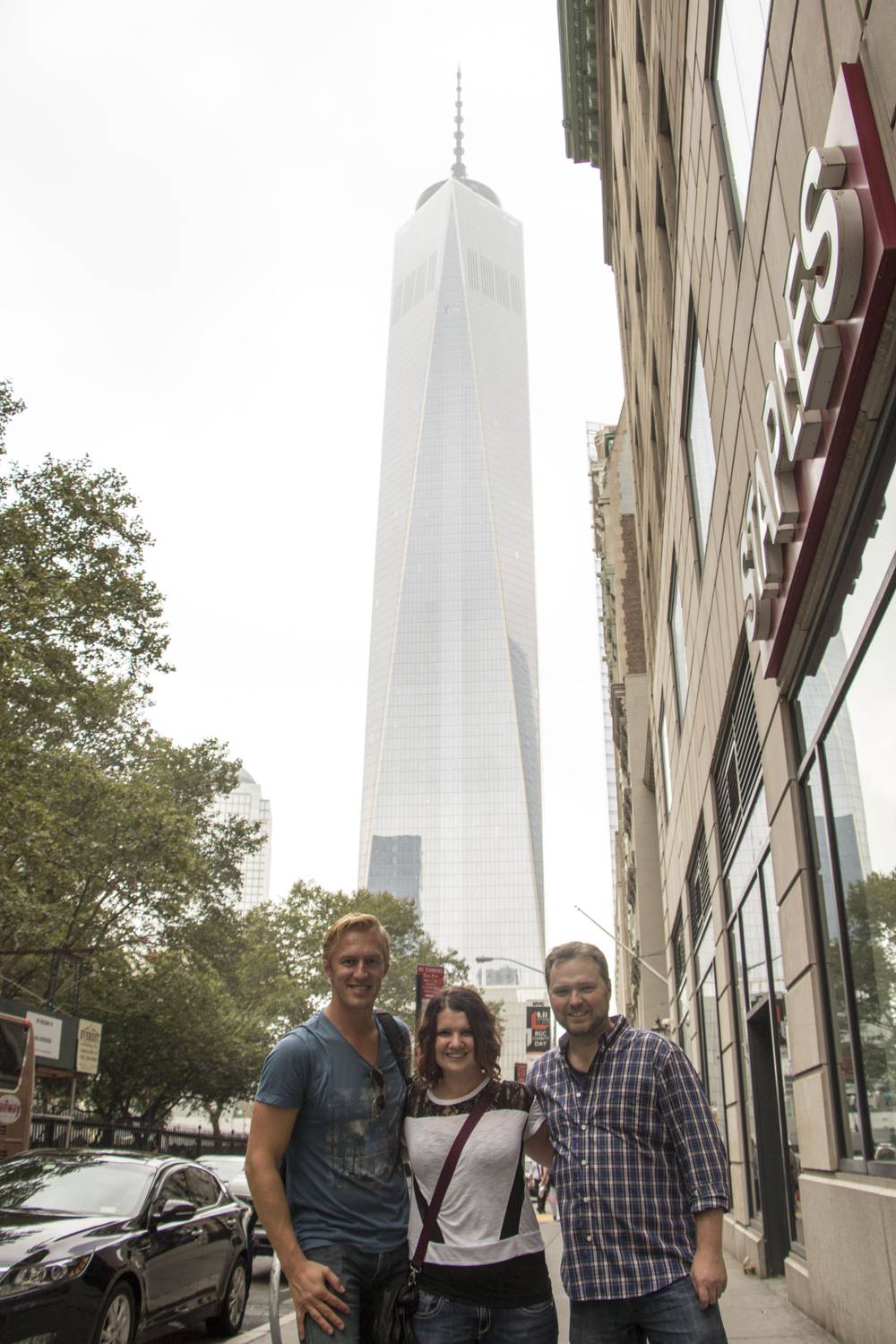One World Trade Center rises above a Lower Manhattan street corner.