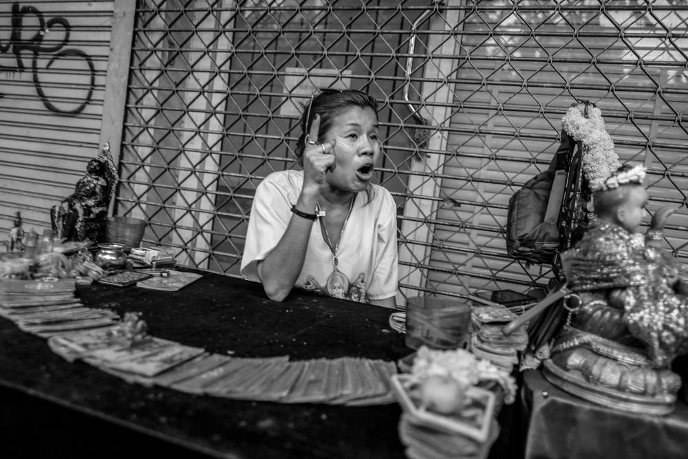 Fortune teller scolding her Luk Thep doll
