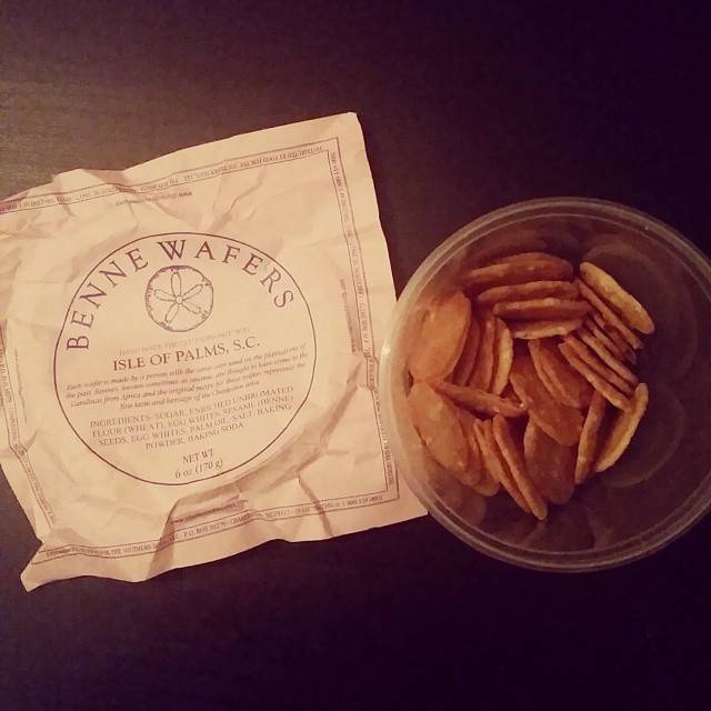 A packet of Benne Wafers beside a small container of the thin wafer cookies.