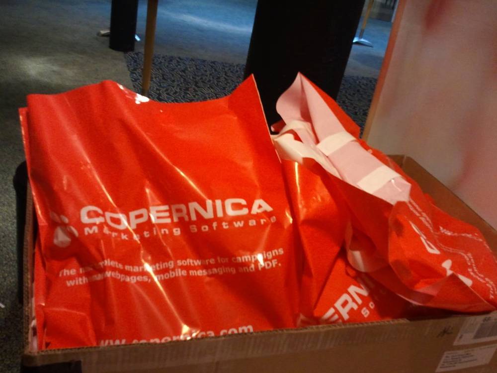 Orange Copernica marketing software bags packed inside a cardboard box.