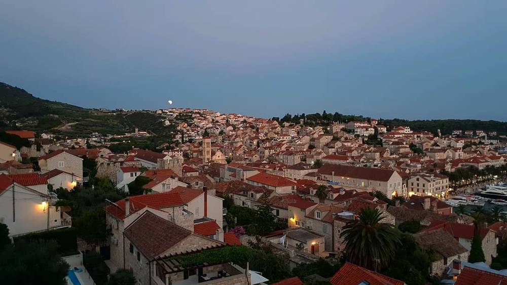 An aerial view of a Croatian coastal town with red-tiled roofs.