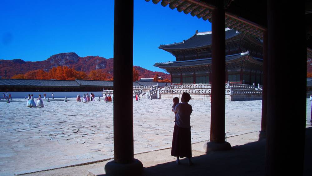 My wife & baby daughter, silhouetted, look out on the courtyard at Gyeongbokgung Palace, in aerochrome-style IR colour