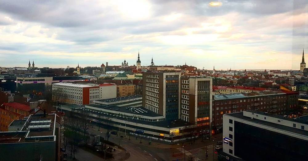 Elevated view over Tallinn's rooftops and towers at dusk.