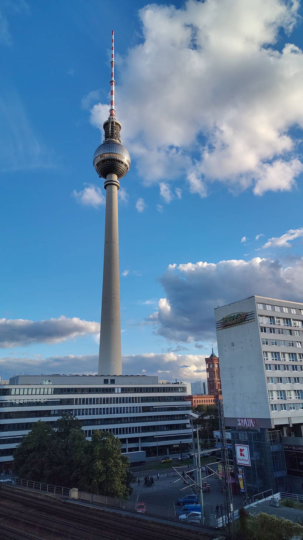 Berlin's TV tower (Fernsehturm) rising above surrounding city buildings.