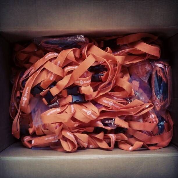 A box full of tangled orange conference lanyards.