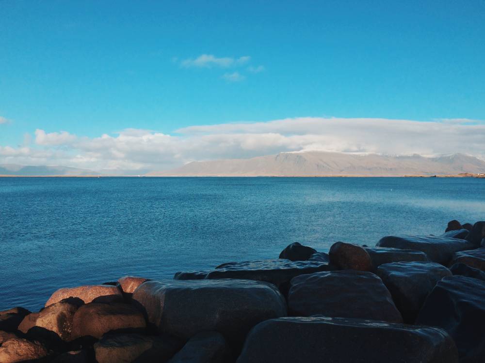 Blue water in the bay with a faint, gray landscape in the background.