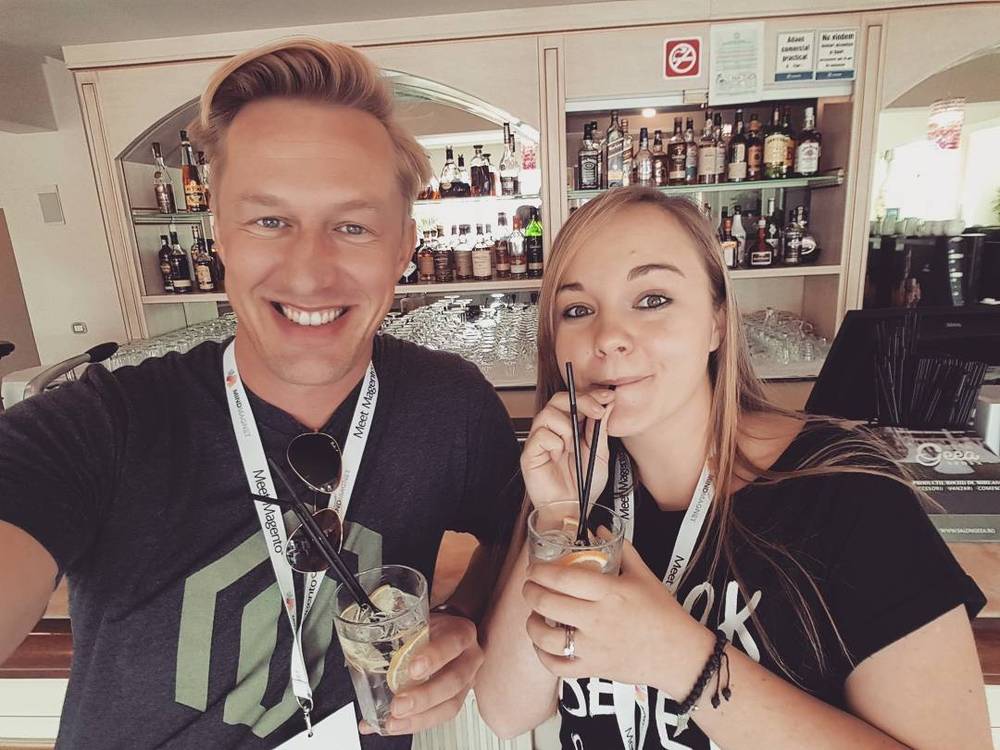 Selfie with a colleague at a hotel bar, both holding drinks with straws.