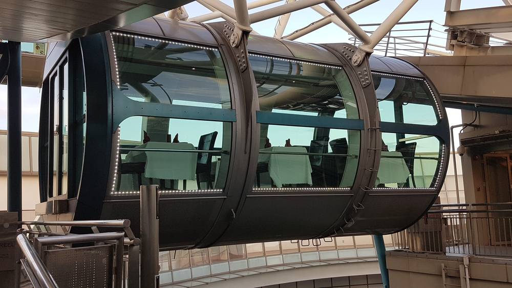 The dining capsule hangs from the Singapore Flyer's wheel structure.