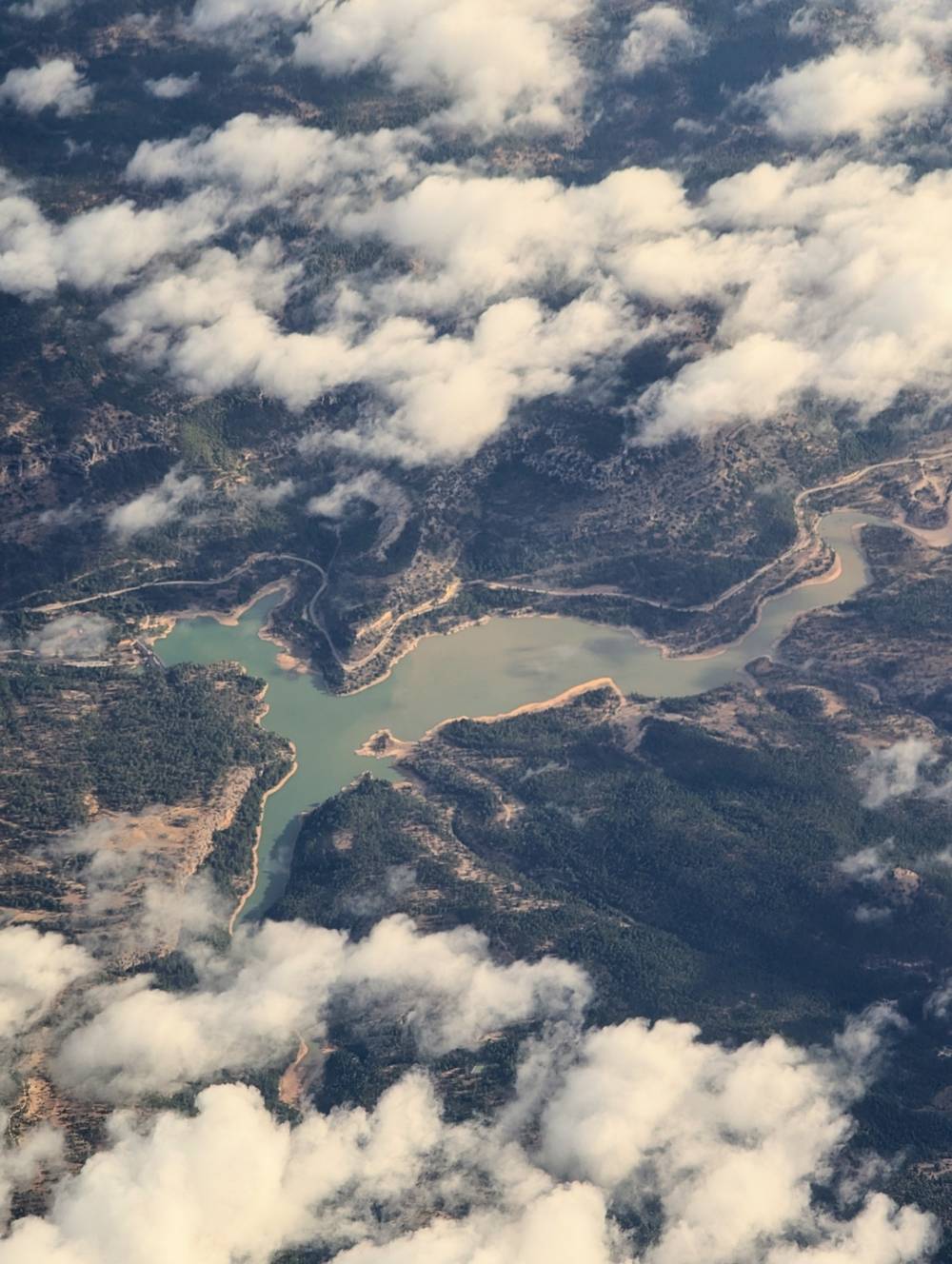 river between the mountains seen through the clouds