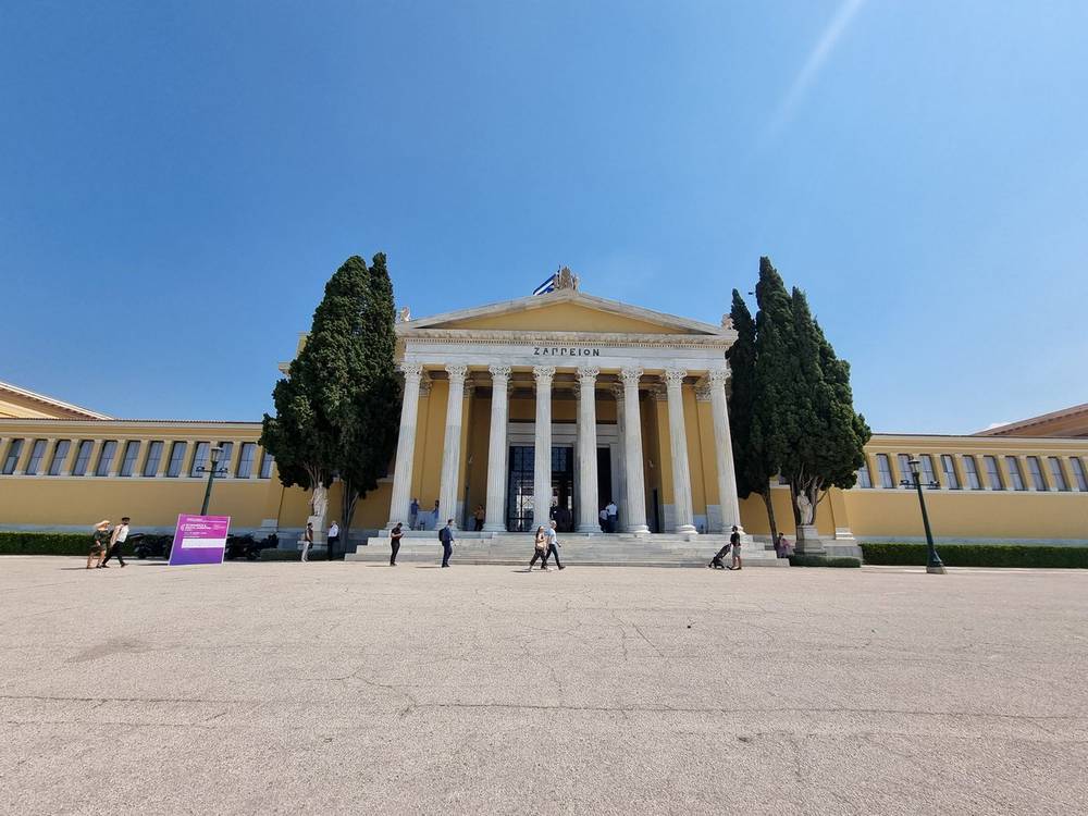 The Zappeion exhibition hall building in Athens under a clear blue sky.