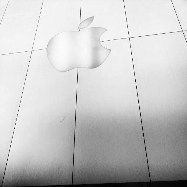 A frosted glass panel etched with the Apple logo.