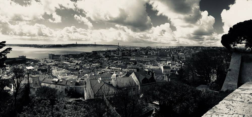 Panoramic photo looking over the rooftops of Lisbon in a high contrast black and white.