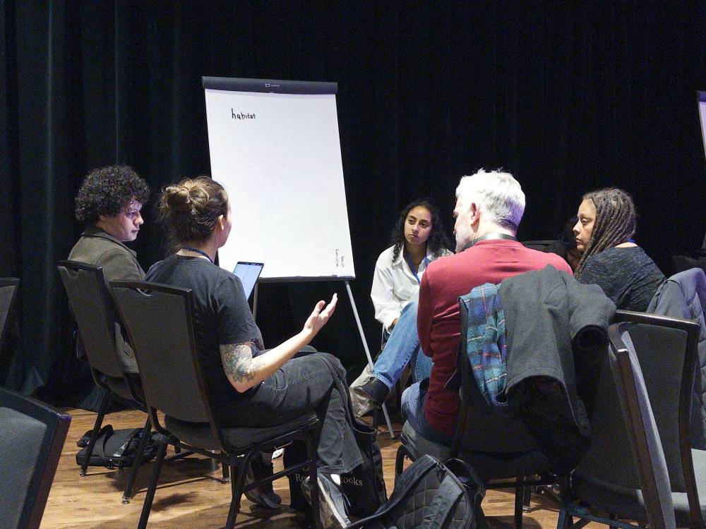 A group of participants and the @habitat.network team discuss their product.