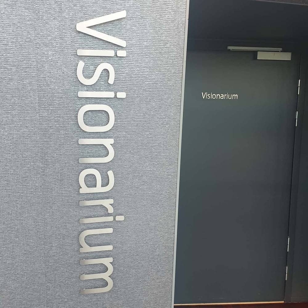 A wall sign reading "Visionarium" beside a door.