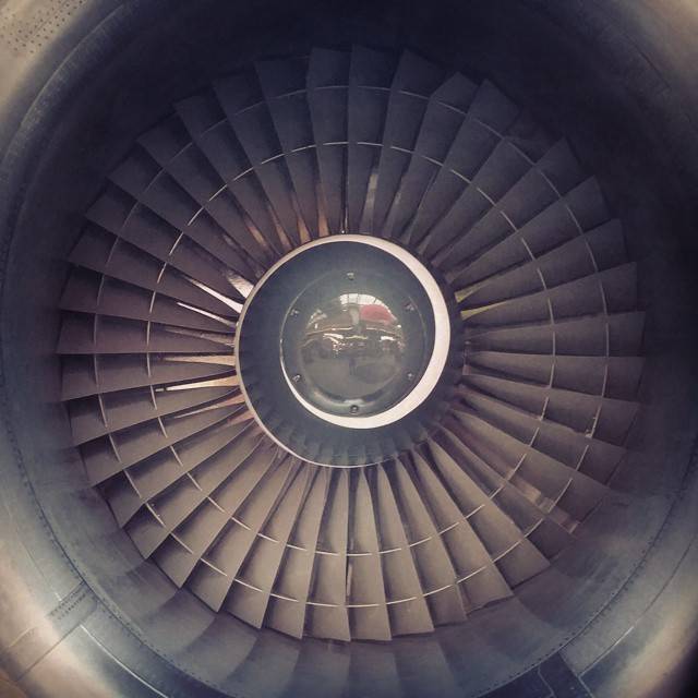 Close-up of a jet engine's turbine blades and intake.