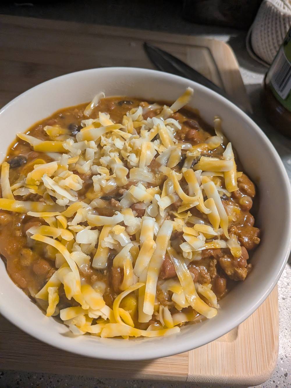 A bowl of chili with cheese