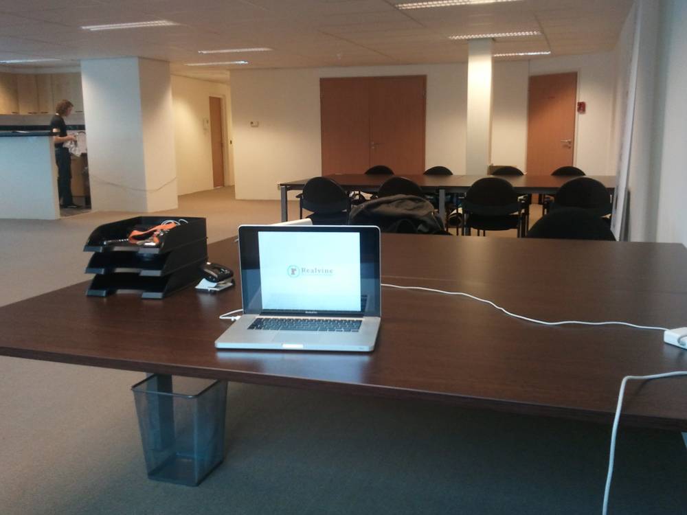 Rows of empty desks and chairs fill the newly arranged office space.