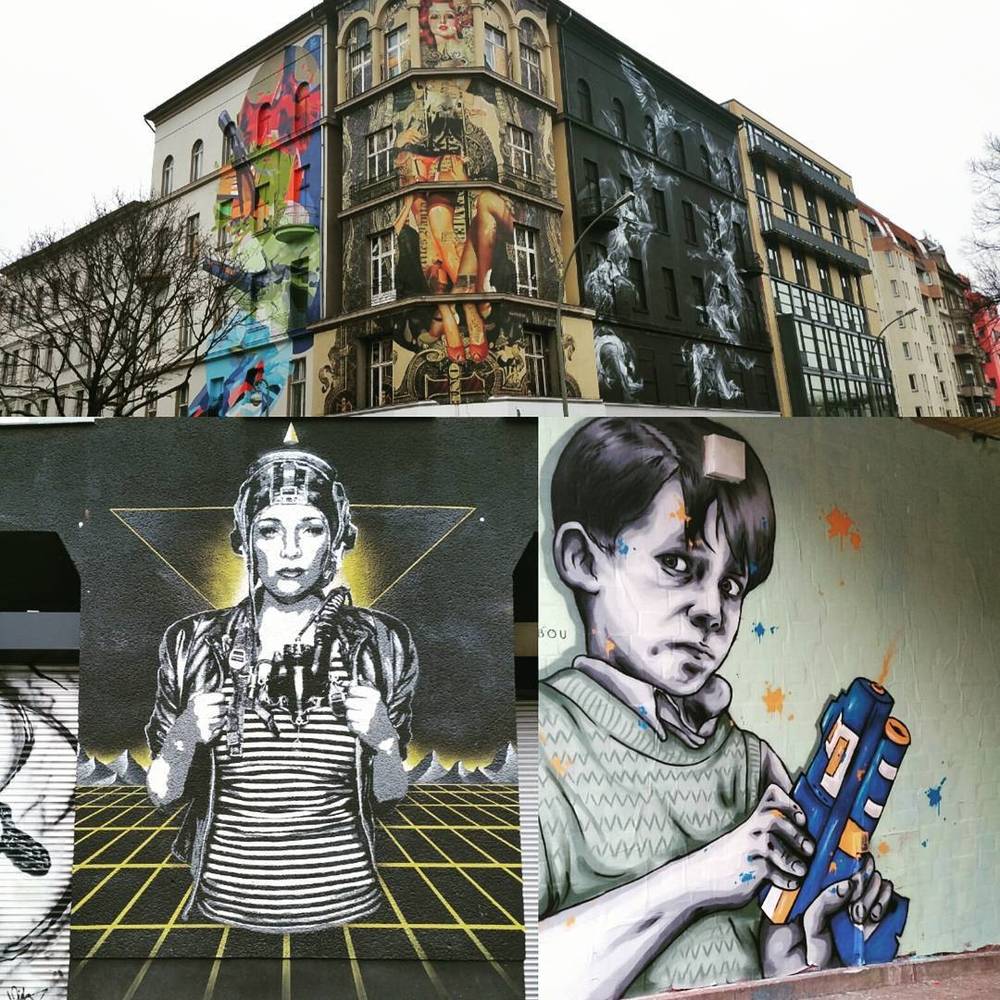 A building covered in colorful street art murals of stylized figures.